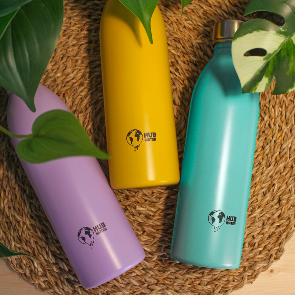 Three water bottles: purple, yellow and blue.